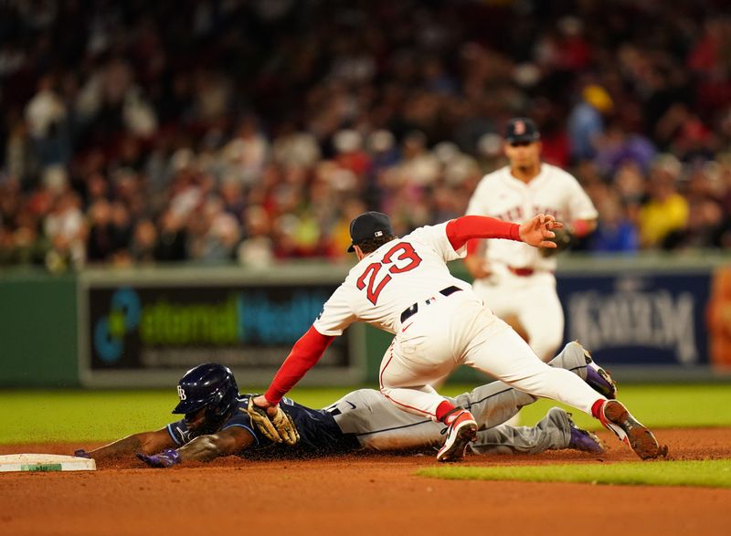 May 13, 2024; Boston, Massachusetts, USA; Tampa Bay Rays left fielder Randy Arozarena (56) tagged out by Boston Red Sox shortstop Romy Gonzalez (23) stealing second base in the seventh inning at Fenway Park. Mandatory Credit: David Butler II-USA TODAY Sports