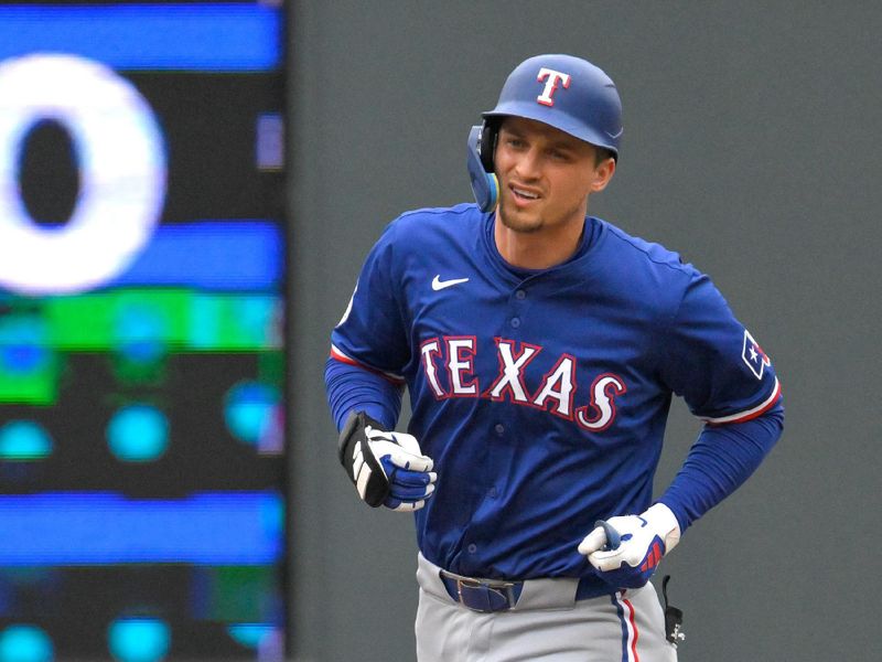 May 26, 2024; Minneapolis, Minnesota, USA;  Texas Rangers infielder Corey Seager (5) rounds the bases after hitting a two-run home run against the Minnesota Twins during the third inning at Target Field. Mandatory Credit: Nick Wosika-USA TODAY Sports