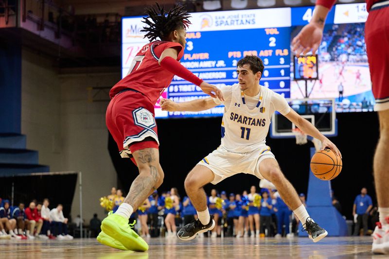 Feb 6, 2024; San Jose, California, USA; San Jose State Spartans guard Alvaro Cardenas (13) dribbles the ball against Fresno State Bulldogs guard Donavan Yap Jr. (0) during the second half at Provident Credit Union Event Center. Mandatory Credit: Robert Edwards-USA TODAY Sports