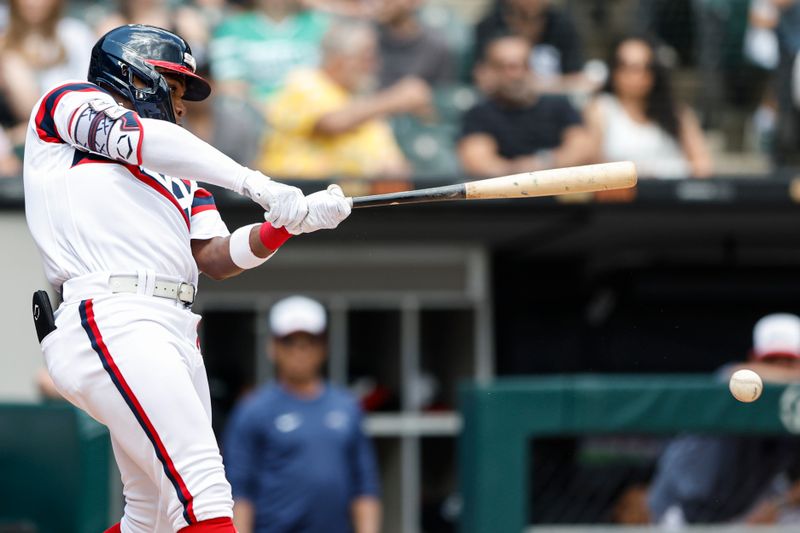 Jul 9, 2023; Chicago, Illinois, USA; Chicago White Sox right fielder Oscar Colas (22) singles against the St. Louis Cardinals during the third inning at Guaranteed Rate Field. Mandatory Credit: Kamil Krzaczynski-USA TODAY Sports