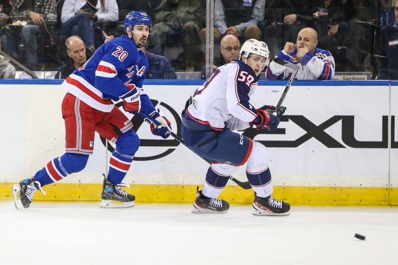 Nov 12, 2023; New York, New York, USA; New York Rangers left wing Chris Kreider (20) and Columbus Blue Jackets right wing Yegor Chinakhov (59)chase the puck in the first period at Madison Square Garden. Mandatory Credit: Wendell Cruz-USA TODAY Sports