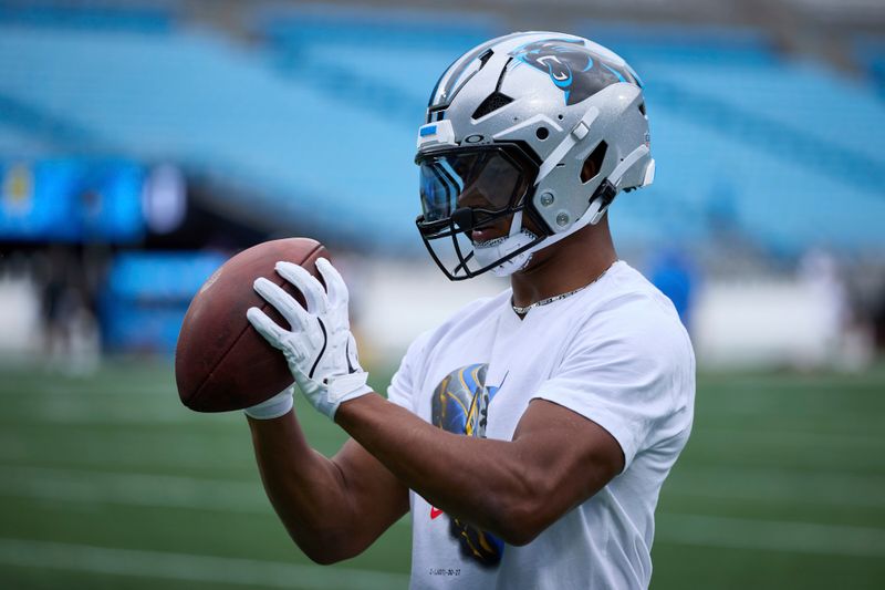 Carolina Panthers running back Chuba Hubbard (30) catches a football prior to an NFL Football game against the Los Angeles Chargers, Sunday, Sep. 15, 2024, in Charlotte, N.C. (AP Photo/Brian Westerholt)