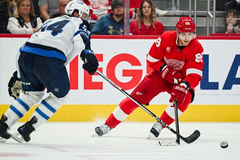 Oct 30, 2024; Detroit, Michigan, USA; Detroit Red Wings right wing Patrick Kane (88) brings the puck up ice against Winnipeg Jets defenseman Dylan Samberg (54) during the second period at Little Caesars Arena. Mandatory Credit: Tim Fuller-Imagn Images