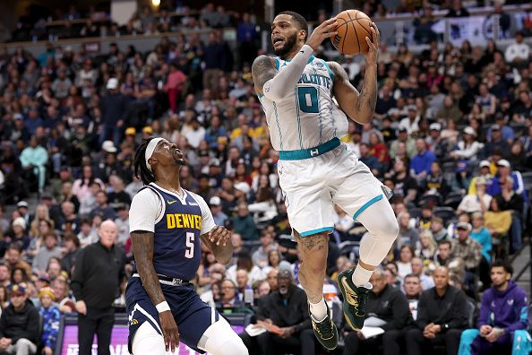 DENVER, COLORADO - JANUARY 01: Miles Bridges #0 of the Charlotte Hornets looks for an outlet while driving against Kentavious Caldwell-Pope #5 of the Denver Nuggets in the third quarter at Ball Arena on January 01, 2024 in Denver, Colorado. NOTE TO USER: User expressly acknowledges and agrees that, by downloading and or using this photograph, User is consenting to the terms and conditions of the Getty Images License Agreement.   (Photo by Matthew Stockman/Getty Images)