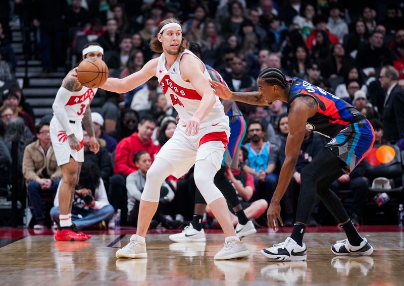 TORONTO, ON - MARCH 25: Kelly Olynyk #41 of the Toronto Raptors posts up against Nic Claxton #33 of the Brooklyn Nets during the first half at the Scotiabank Arena on March 25, 2024 in Toronto, Ontario, Canada. NOTE TO USER: User expressly acknowledges and agrees that, by downloading and/or using this Photograph, user is consenting to the terms and conditions of the Getty Images License Agreement. (Photo by Mark Blinch/Getty Images)