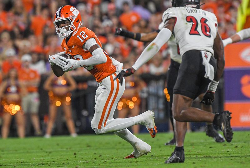 Nov 2, 2024; Clemson, South Carolina, USA; Clemson Tigers wide receiver Bryant Wesco Jr. (12) runs against Louisville Cardinals defensive back MJ Griffin (26) during the second quarter at Memorial Stadium. Mandatory Credit: Ken Ruinard-Imagn Images