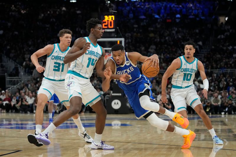 MILWAUKEE, WISCONSIN - NOVEMBER 23: Giannis Antetokounmpo #34 of the Milwaukee Bucks dribbles the ball against Moussa Diabate #14 of the Charlotte Hornets during the second quarter of a a game at Fiserv Forum on November 23, 2024 in Milwaukee, Wisconsin. NOTE TO USER: User expressly acknowledges and agrees that, by downloading and or using this photograph, User is consenting to the terms and conditions of the Getty Images License Agreement. (Photo by Patrick McDermott/Getty Images)