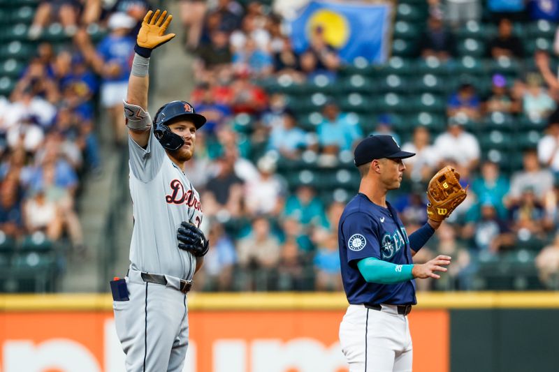 Aug 8, 2024; Seattle, Washington, USA; Detroit Tigers center fielder Parker Meadows (22) waves to the dugout after hitting an RBI-double against the Seattle Mariners during the fifth inning at T-Mobile Park. Seattle Mariners shortstop Dylan Moore (25) stands at right. Mandatory Credit: Joe Nicholson-USA TODAY Sports