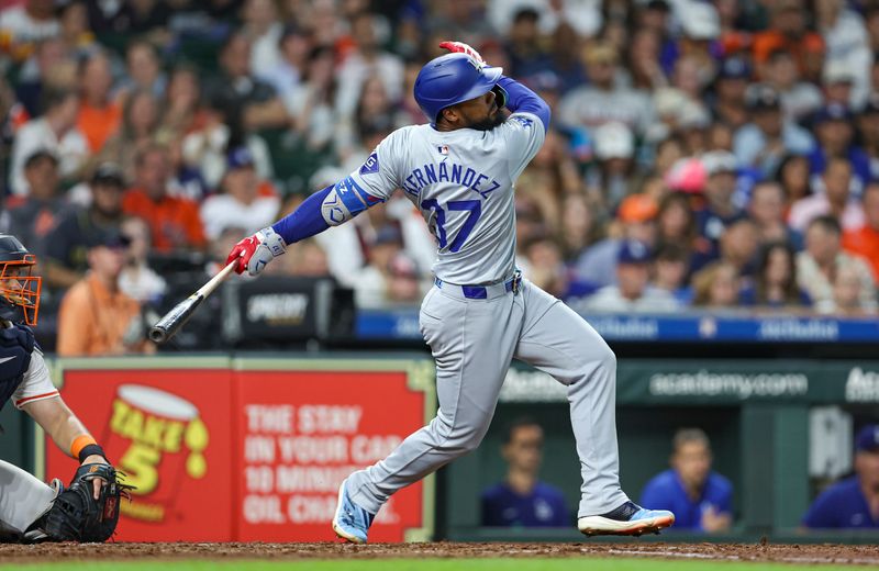 Jul 27, 2024; Houston, Texas, USA; Los Angeles Dodgers left fielder Teoscar Hernandez (37) hits an RBI single during the fifth inning against the Houston Astros at Minute Maid Park. Mandatory Credit: Troy Taormina-USA TODAY Sports