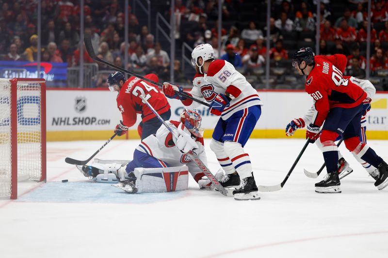 Oct 31, 2024; Washington, District of Columbia, USA; Washington Capitals center Connor McMichael (24) scores a goal on Montreal Canadiens goaltender Cayden Primeau (30) in the third period at Capital One Arena. Mandatory Credit: Geoff Burke-Imagn Images