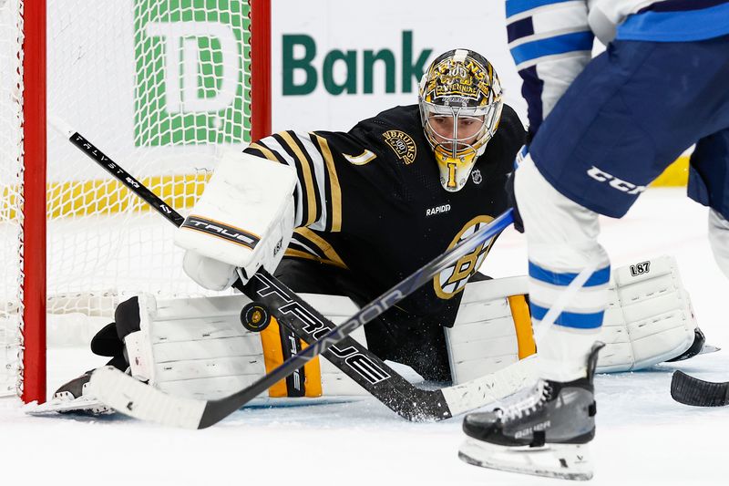 Jan 22, 2024; Boston, Massachusetts, USA; Boston Bruins goaltender Jeremy Swayman (1) makes a save against the Winnipeg Jets during the third period at TD Garden. Mandatory Credit: Winslow Townson-USA TODAY Sports