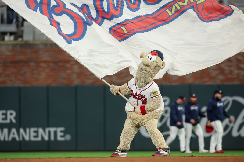 Sep 24, 2024; Atlanta, Georgia, USA; Atlanta Braves mascot Blooper waves a flag after a victory over the New York Mets at Truist Park. Mandatory Credit: Brett Davis-Imagn Images
