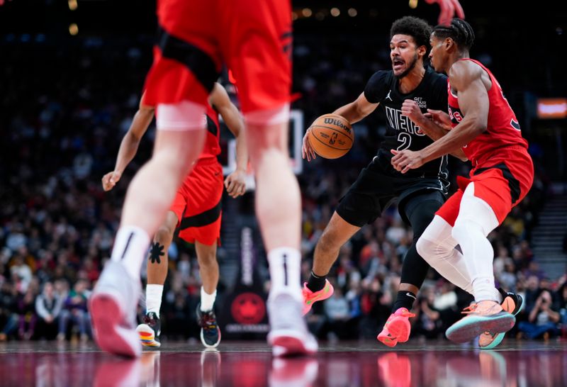 TORONTO, ON - JANUARY 1: Cameron Johnson #2 of the Brooklyn Nets dribbles against Ochai Agbaji #30 of the Toronto Raptors during the second half at the Scotiabank Arena on January 1, 2025 in Toronto, Ontario, Canada. NOTE TO USER: User expressly acknowledges and agrees that, by downloading and/or using this Photograph, user is consenting to the terms and conditions of the Getty Images License Agreement. (Photo by Mark Blinch/Getty Images)