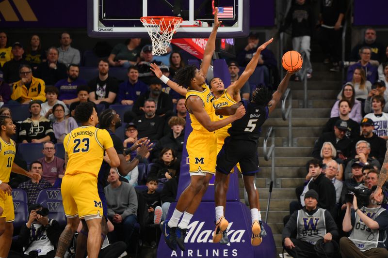 Jan 14, 2026; Seattle, Washington, USA; Washington Huskies guard Zoom Diallo (5) shoots the ball over Michigan Wolverines forward Morez Johnson Jr. (21) and guard Nimari Burnett (4) during the second half at Alaska Airlines Arena at Hec Edmundson Pavilion. Mandatory Credit: Steven Bisig-Imagn Images