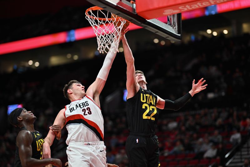 PORTLAND, OREGON - OCTOBER 18: Donovan Clingan #23 of the Portland Trail Blazers and Kyle Filipowski #22 of the Utah Jazz reach for a rebound during the fourth quarter of the preseason game at Moda Center on October 18, 2024 in Portland, Oregon. The Portland Trail Blazers won 124-86. NOTE TO USER: User expressly acknowledges and agrees that, by downloading and or using this photograph, User is consenting to the terms and conditions of the Getty Images License Agreement. (Photo by Alika Jenner/Getty Images)