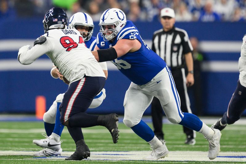 Indianapolis Colts guard Quenton Nelson (56) blocks Houston Texans defensive tackle Khalil Davis (94) during an NFL football game, Saturday, Jan. 6, 2024, in Indianapolis. (AP Photo/Zach Bolinger)