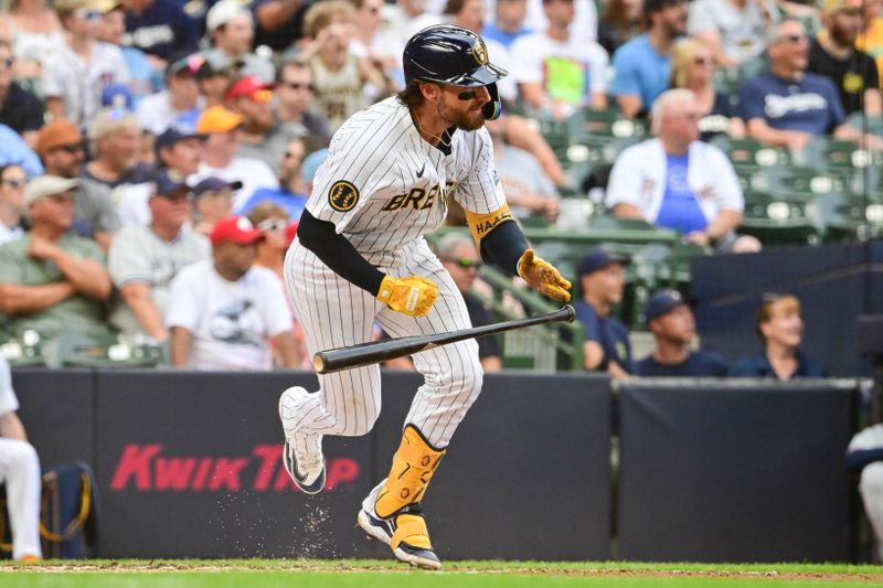 Jul 13, 2024; Milwaukee, Wisconsin, USA; Milwaukee Brewers catcher Eric Haase (13) hits a single to drive in two runs in the first inning against the Washington Nationals at American Family Field. Mandatory Credit: Benny Sieu-USA TODAY Sports