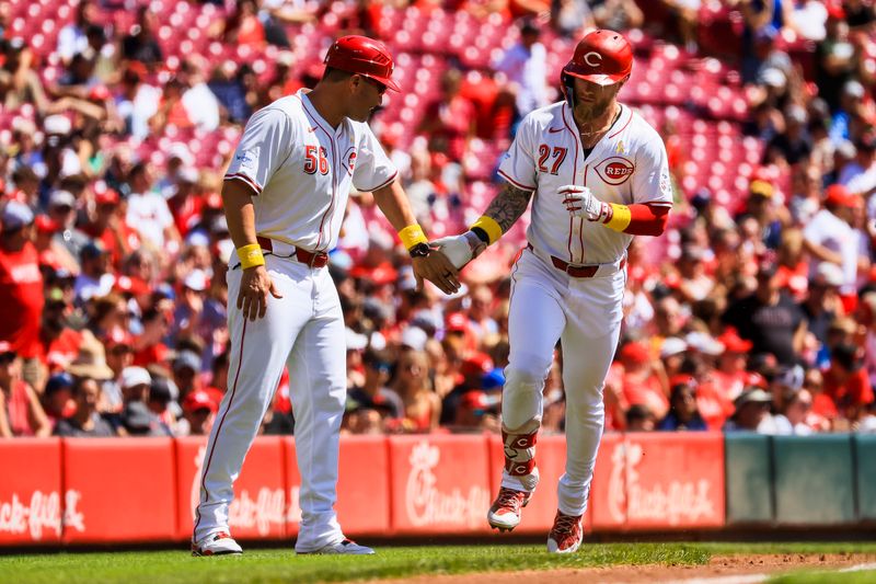 Sep 1, 2024; Cincinnati, Ohio, USA; Cincinnati Reds outfielder Jake Fraley (27) high fives third base coach J.R. House (56) after hitting a solo home run in the second inning against the Milwaukee Brewers at Great American Ball Park. Mandatory Credit: Katie Stratman-USA TODAY Sports