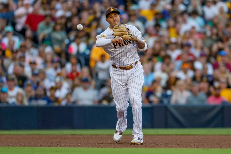 Jul 29, 2023; San Diego, California, USA;  San Diego Padres third baseman Manny Machado (13) makes the play to first for out the out during the fifth inning against the Texas Rangers at Petco Park. Mandatory Credit: David Frerker-USA TODAY Sports