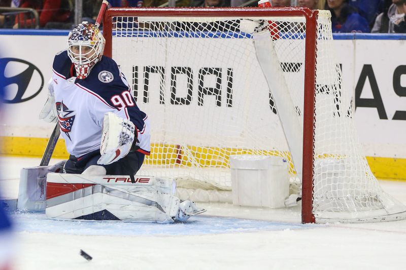 Nov 12, 2023; New York, New York, USA; Columbus Blue Jackets goaltender Elvis Merzlikins (90) watches the puck during a shot on goal attempt in the third period against the New York Rangers at Madison Square Garden. Mandatory Credit: Wendell Cruz-USA TODAY Sports