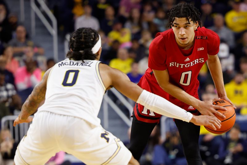 Feb 3, 2024; Ann Arbor, Michigan, USA;  Rutgers Scarlet Knights guard Derek Simpson (0) dribbles against Michigan Wolverines guard Dug McDaniel (0) in the second half at Crisler Center. Mandatory Credit: Rick Osentoski-USA TODAY Sports