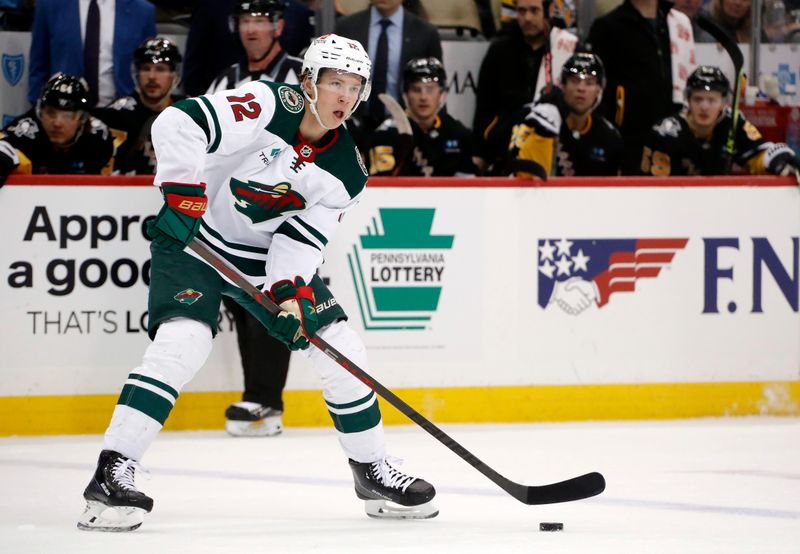 Apr 6, 2023; Pittsburgh, Pennsylvania, USA; Minnesota Wild left wing Matt Boldy (12) handles the puck against the Pittsburgh Penguins during the first period at PPG Paints Arena. Mandatory Credit: Charles LeClaire-USA TODAY Sports