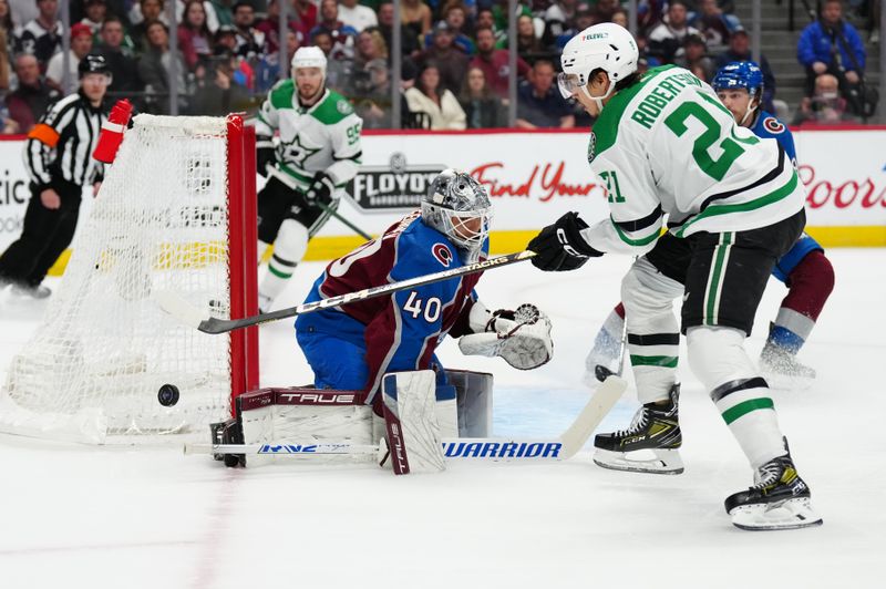 May 17, 2024; Denver, Colorado, USA; Dallas Stars left wing Jason Robertson (21) shoots the puck at Colorado Avalanche goaltender Alexandar Georgiev (40) in the first period in game six of the second round of the 2024 Stanley Cup Playoffs at Ball Arena. Mandatory Credit: Ron Chenoy-USA TODAY Sports