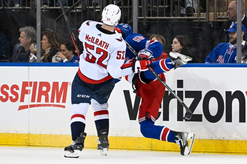 Apr 23, 2024; New York, New York, USA;  Washington Capitals defenseman Dylan McIlrath (52) checks New York Rangers defenseman Ryan Lindgren (55) during the third period in game two of the first round of the 2024 Stanley Cup Playoffs at Madison Square Garden. Mandatory Credit: Dennis Schneidler-USA TODAY Sports