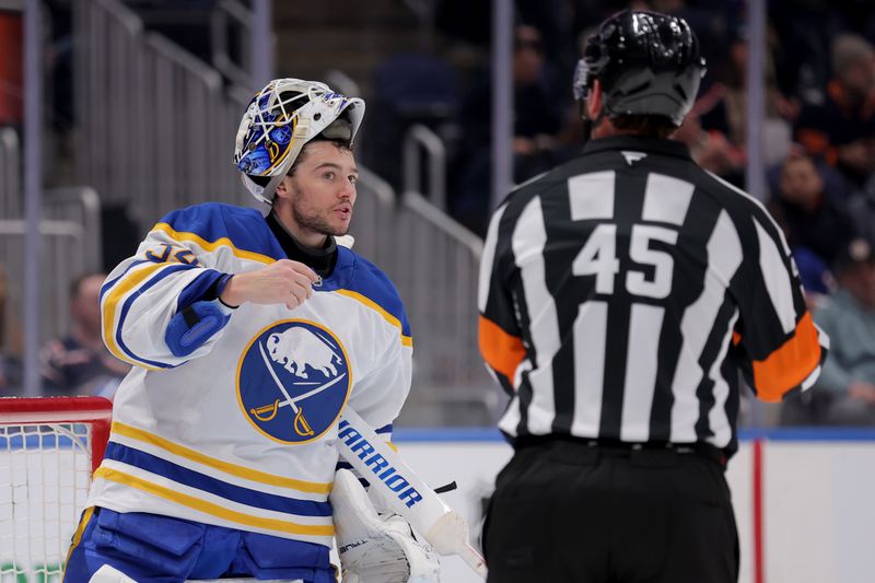 Jan 24, 2026; Elmont, New York, USA; Buffalo Sabres goaltender Alex Lyon (34) talks to referee Liam Maaskant (45) during the second period against the New York Islanders at UBS Arena. Mandatory Credit: Brad Penner-Imagn Images