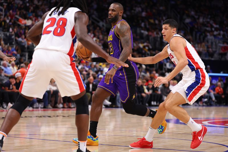 DETROIT, MICHIGAN - NOVEMBER 04: LeBron James #23 of the Los Angeles Lakers looks to pass the ball against Isaiah Stewart #28 and Simone Fontecchio #19 of the Detroit Pistons during the second quarter at Little Caesars Arena on November 04, 2024 in Detroit, Michigan. NOTE TO USER: User expressly acknowledges and agrees that, by downloading and/or using this photograph, user is consenting to the terms and conditions of the Getty Images License Agreement.  (Photo by Gregory Shamus/Getty Images)