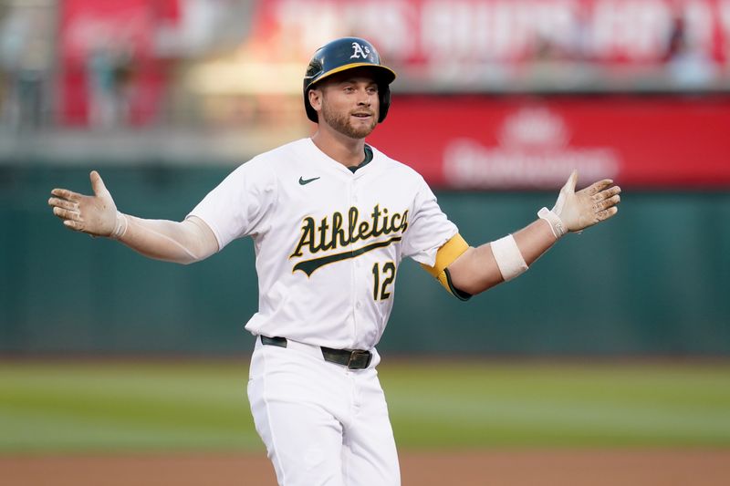 Jul 19, 2024; Oakland, California, USA; Oakland Athletics shortstop Max Schuemann (12) reacts after hitting a three-run home run against the Los Angeles Angels in the fourth inning at Oakland-Alameda County Coliseum. Mandatory Credit: Cary Edmondson-USA TODAY Sports