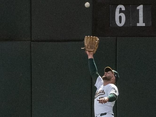 Jun 4, 2024; Oakland, California, USA; Oakland Athletics outfielder Seth Brown (15) makes a catch during the seventh inning against the Seattle Mariners at Oakland-Alameda County Coliseum. Mandatory Credit: Ed Szczepanski-USA TODAY Sports