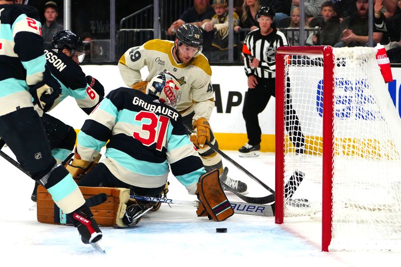 Mar 21, 2024; Las Vegas, Nevada, USA; Vegas Golden Knights center Ivan Barbashev (49) centers the puck underneath the stick of Seattle Kraken goaltender Philipp Grubauer (31) during the second period at T-Mobile Arena. Mandatory Credit: Stephen R. Sylvanie-USA TODAY Sports