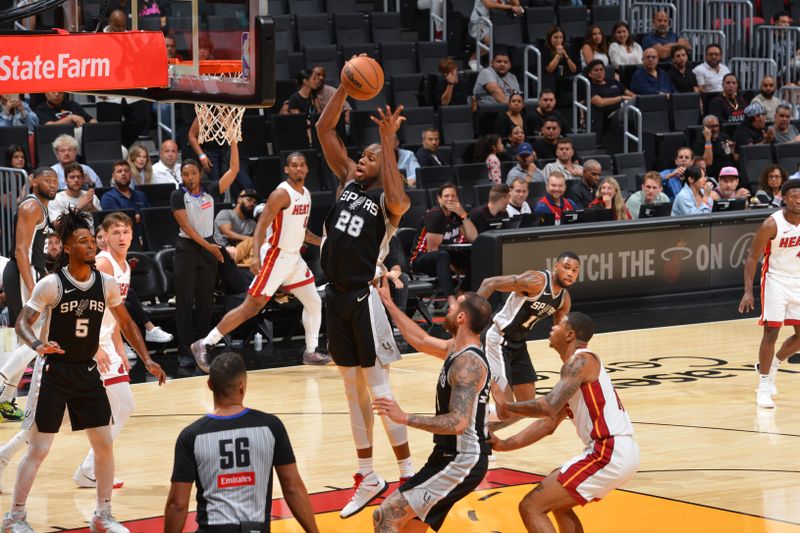 MIAMI, FL - OCTOBER 15: Charles Bassey #28 of the San Antonio Spurs rebounds the ball during the game against the Miami Heat during a NBA preseason game on October 15, 2024 at Kaseya Center in Miami, Florida. NOTE TO USER: User expressly acknowledges and agrees that, by downloading and or using this Photograph, user is consenting to the terms and conditions of the Getty Images License Agreement. Mandatory Copyright Notice: Copyright 2024 NBAE (Photo by Jesse D. Garrabrant/NBAE via Getty Images)