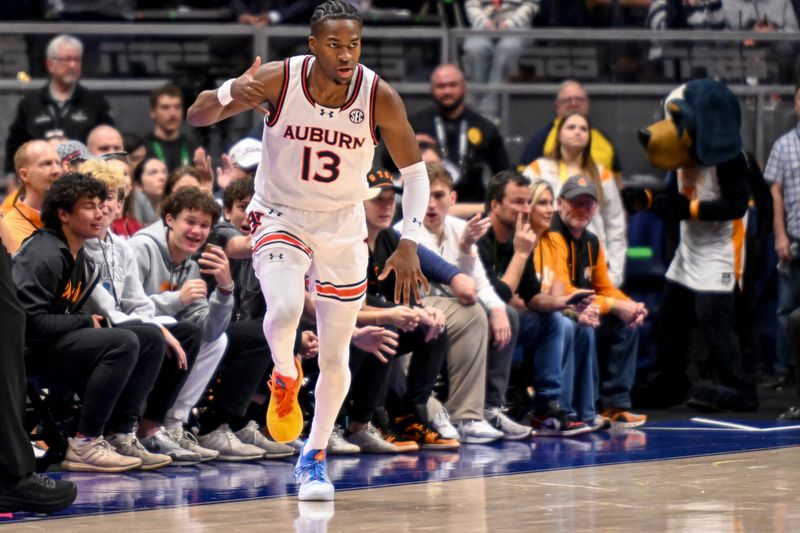 Mar 15, 2025; Nashville, TN, USA;  Auburn Tigers guard Miles Kelly (13) reacts after a made three point basket  against the Tennessee Volunteers during the first half at Bridgestone Arena. Mandatory Credit: Steve Roberts-Imagn Images