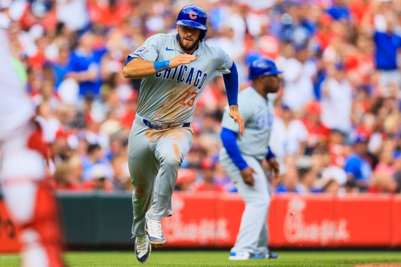 Jun 8, 2024; Cincinnati, Ohio, USA; Chicago Cubs second baseman David Bote (13) scores on a double hit by catcher Yan Gomes (not pictured) in the sixth inning against the Cincinnati Reds at Great American Ball Park. Mandatory Credit: Katie Stratman-USA TODAY Sports