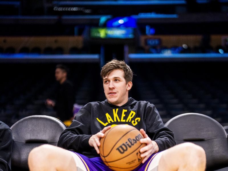 LOS ANGELES, CA - MARCH 12:  Austin Reaves #15 of the Los Angeles Lakers sits courtside before the game on March 12, 2023 at Crypto.Com Arena in Los Angeles, California. NOTE TO USER: User expressly acknowledges and agrees that, by downloading and/or using this Photograph, user is consenting to the terms and conditions of the Getty Images License Agreement. Mandatory Copyright Notice: Copyright 2023 NBAE (Photo by Tyler Ross/NBAE via Getty Images)