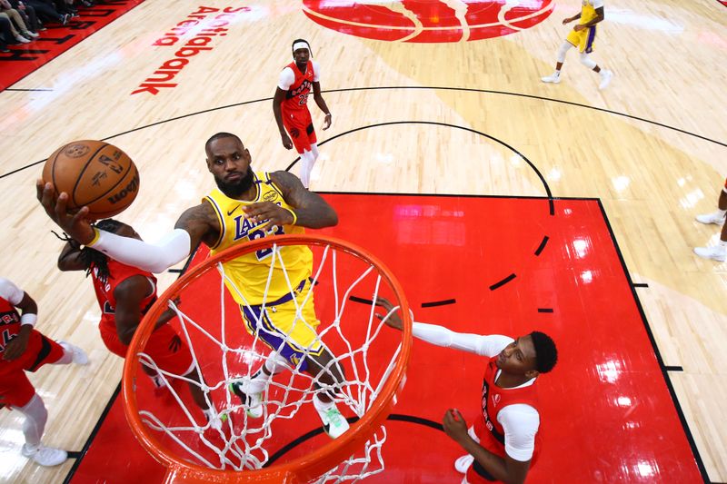 TORONTO, CANADA - NOVEMBER 1: LeBron James #23 of the Los Angeles Lakers drives to the basket during the game against the Toronto Raptors on November 1, 2024 at the Scotiabank Arena in Toronto, Ontario, Canada.  NOTE TO USER: User expressly acknowledges and agrees that, by downloading and or using this Photograph, user is consenting to the terms and conditions of the Getty Images License Agreement.  Mandatory Copyright Notice: Copyright 2024 NBAE (Photo by Vaughn Ridley/NBAE via Getty Images)