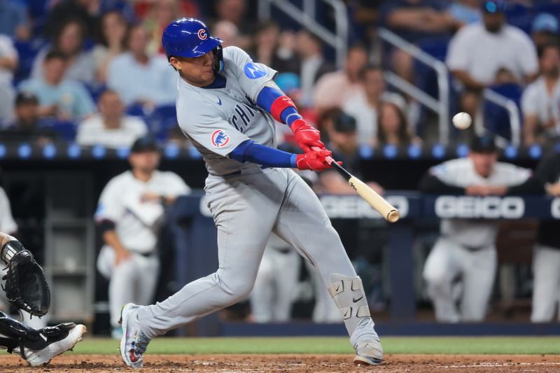 May 19, 2025; Miami, Florida, USA; Chicago Cubs catcher Miguel Amaya (9) hits a three-run home run against the Miami Marlins during the fourth inning at loanDepot Park. Mandatory Credit: Sam Navarro-Imagn Images
