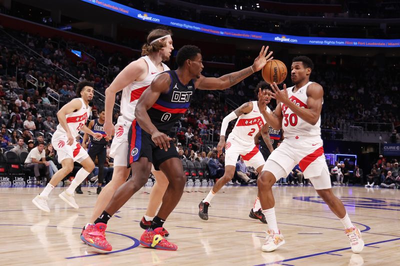 DETROIT, MICHIGAN - MARCH 13: Jalen Duren #0 of the Detroit Pistons loses control of the ball next to Ochai Agbaji #30 of the Toronto Raptors during the first half at Little Caesars Arena on March 13, 2024 in Detroit, Michigan. NOTE TO USER: User expressly acknowledges and agrees that, by downloading and or using this photograph, User is consenting to the terms and conditions of the Getty Images License.  (Photo by Gregory Shamus/Getty Images)