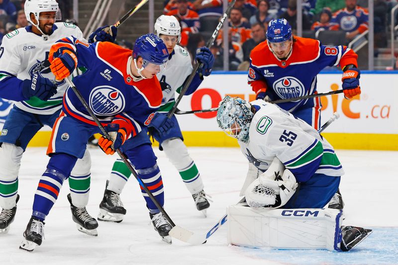 Sep 28, 2025; Edmonton, Alberta, CAN; Edmonton Oilers forward Josh Samanski (81) looks for a loose puck in front of Vancouver Canucks goaltender Thatcher Demko (35) during the third period at Rogers Place. Mandatory Credit: Perry Nelson-Imagn Images