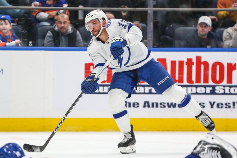 Feb 24, 2024; Elmont, New York, USA;  Tampa Bay Lightning center Luke Glendening (11) takes a shot on goal in the third period against the New York Islanders at UBS Arena. Mandatory Credit: Wendell Cruz-USA TODAY Sports