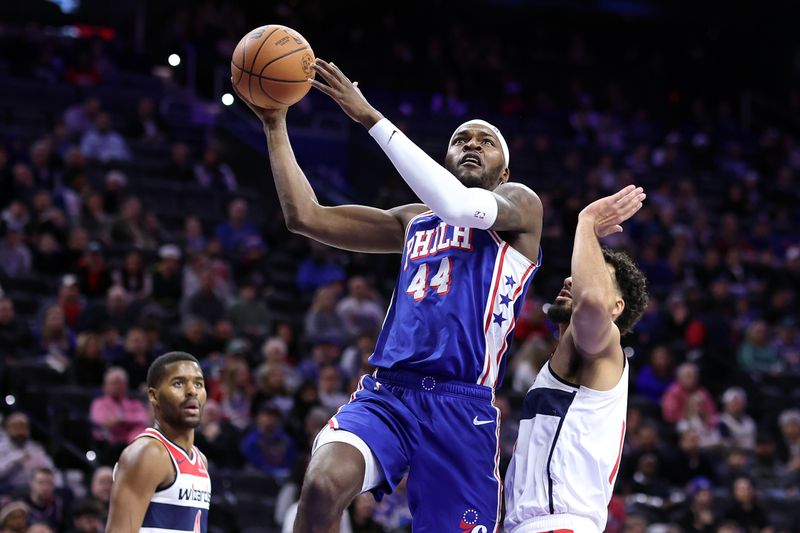 PHILADELPHIA, PENNSYLVANIA - DECEMBER 11: Paul Reed #44 of the Philadelphia 76ers shoots a lay up past Anthony Gill #16 of the Washington Wizards during the fourth quarter at the Wells Fargo Center on December 11, 2023 in Philadelphia, Pennsylvania. (Photo by Tim Nwachukwu/Getty Images)