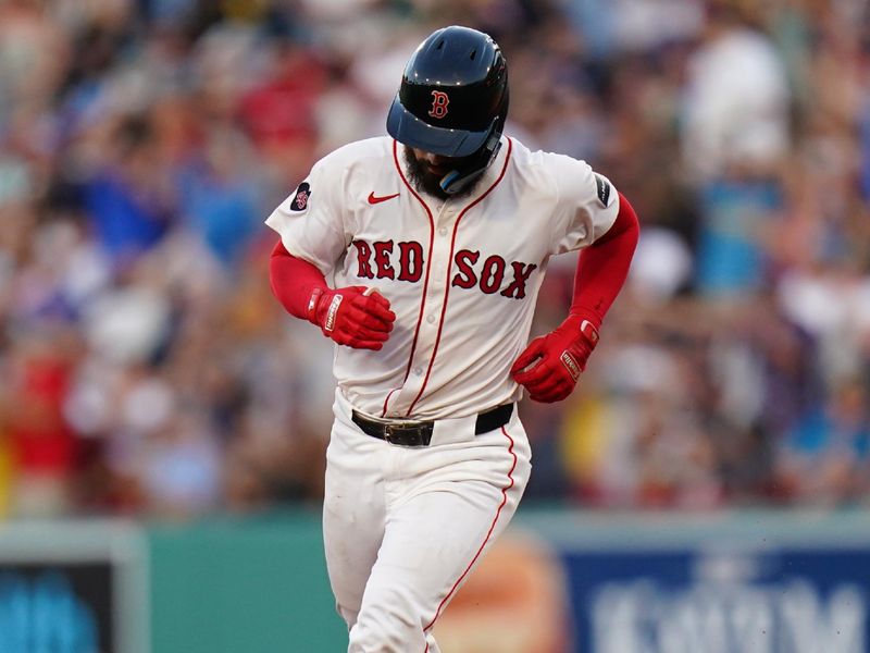 Jul 11, 2024; Boston, Massachusetts, USA; Boston Red Sox catcher Connor Wong (12) hits a home run against the Oakland Athletics in the third inning at Fenway Park. Mandatory Credit: David Butler II-USA TODAY Sports