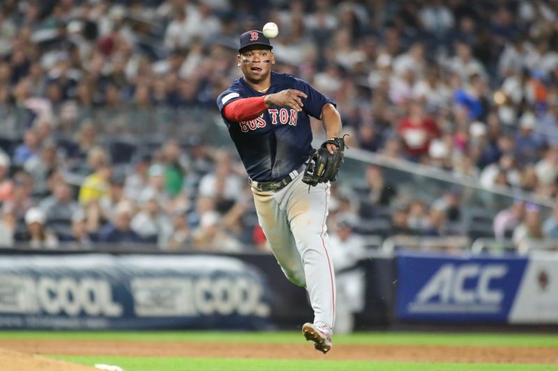 Aug 18, 2023; Bronx, New York, USA; Boston Red Sox third baseman Rafael Devers (11) makes a running throw to first base in the third inning against the New York Yankees at Yankee Stadium. Mandatory Credit: Wendell Cruz-USA TODAY Sports