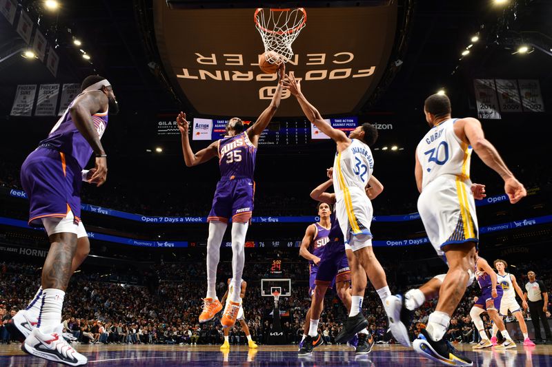 PHOENIX, AZ - NOVEMBER 30: Kevin Durant #35 of the Phoenix Suns rebounds the ball during the game against the Golden State Warriors on November 30, 2024 at Footprint Center in Phoenix, Arizona. NOTE TO USER: User expressly acknowledges and agrees that, by downloading and or using this photograph, user is consenting to the terms and conditions of the Getty Images License Agreement. Mandatory Copyright Notice: Copyright 2024 NBAE (Photo by Barry Gossage/NBAE via Getty Images)