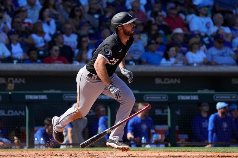 Mar 1, 2024; Mesa, Arizona, USA; Chicago White Sox shortstop Paul DeJong (29) hits a sacrifice RBI fly out against the Chicago Cubs during the third inning at Sloan Park. Mandatory Credit: Rick Scuteri-USA TODAY Sports