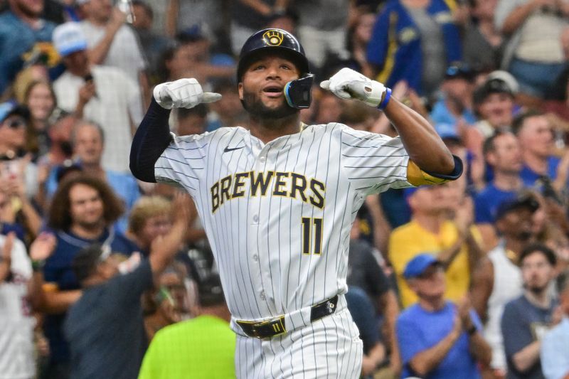 Jul 28, 2024; Milwaukee, Wisconsin, USA; Milwaukee Brewers left fielder Jackson Chourio (11) reacts after hitting a solo home run in the fifth inning against the Miami Marlins at American Family Field. Mandatory Credit: Benny Sieu-USA TODAY Sports