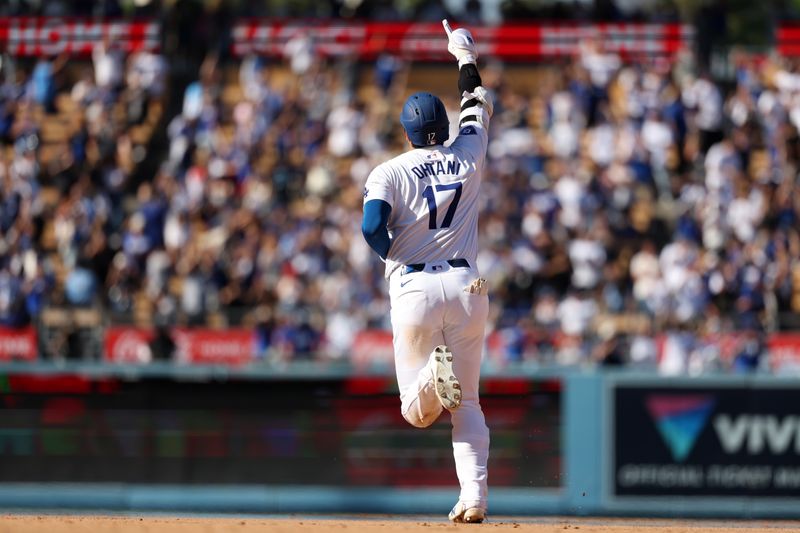 Sep 22, 2024; Los Angeles, California, USA;  Los Angeles Dodgers designated hitter Shohei Ohtani (17) celebrates on a game tying solo home run during the ninth inning against the Colorado Rockies at Dodger Stadium. Mandatory Credit: Kiyoshi Mio-Imagn Images