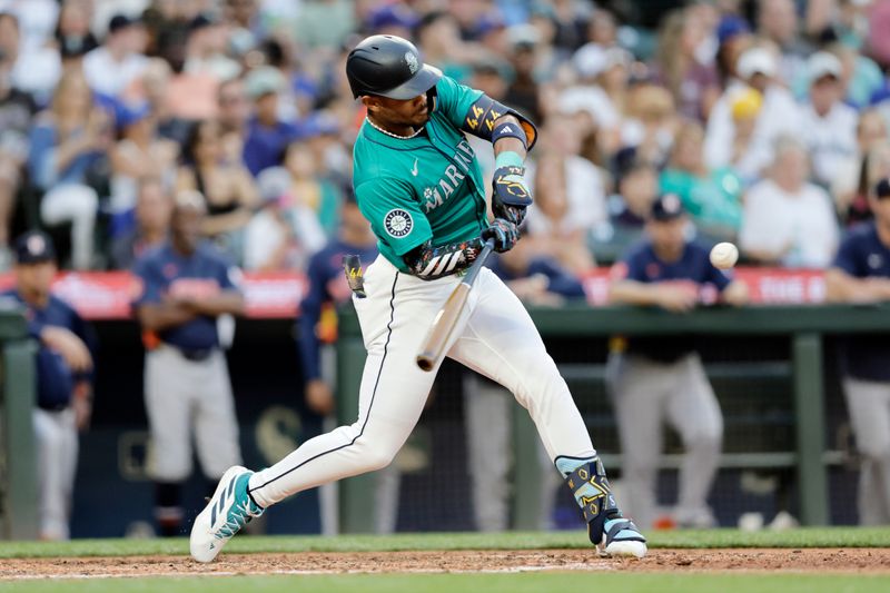 Jul 20, 2024; Seattle, Washington, USA; Seattle Mariners center fielder Julio Rodríguez (44) hits a two-run home run against the Houston Astros during the sixth inning at T-Mobile Park. Mandatory Credit: John Froschauer-USA TODAY Sports